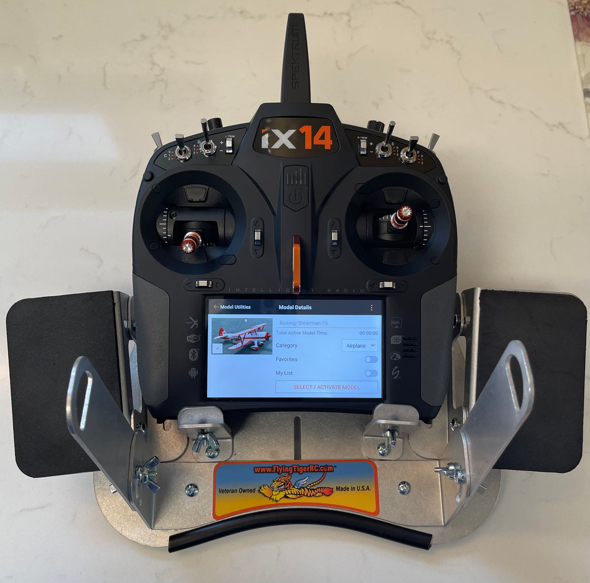 Spektrum iX14 radio seated in the Flying Tiger RC transmitter tray with both neoprene hand pads fitted, front view