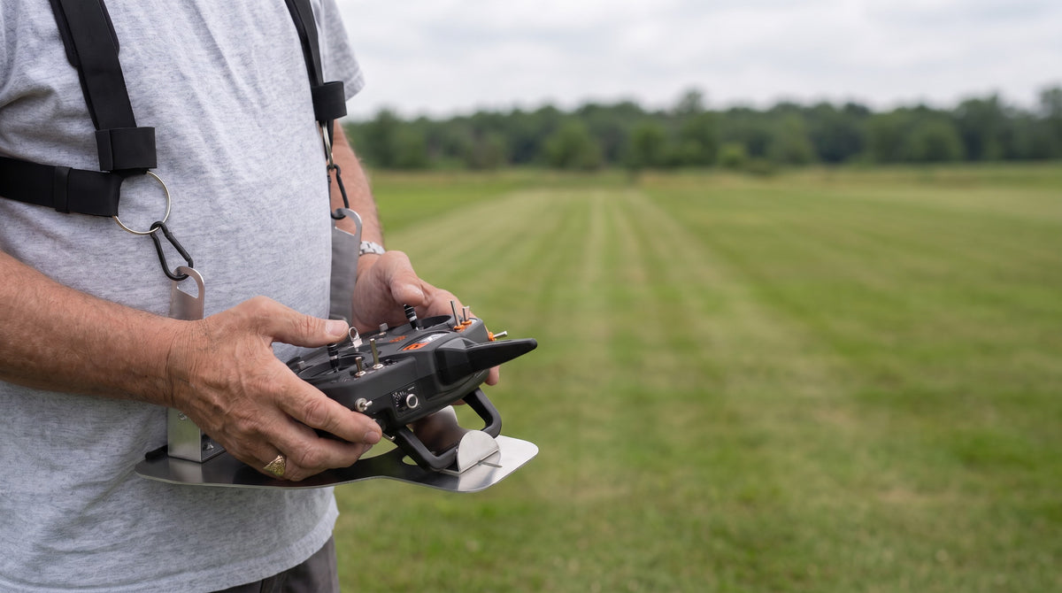 Pilot wearing the Flying Tiger RC transmitter tray on a two-point shoulder harness at a flying field