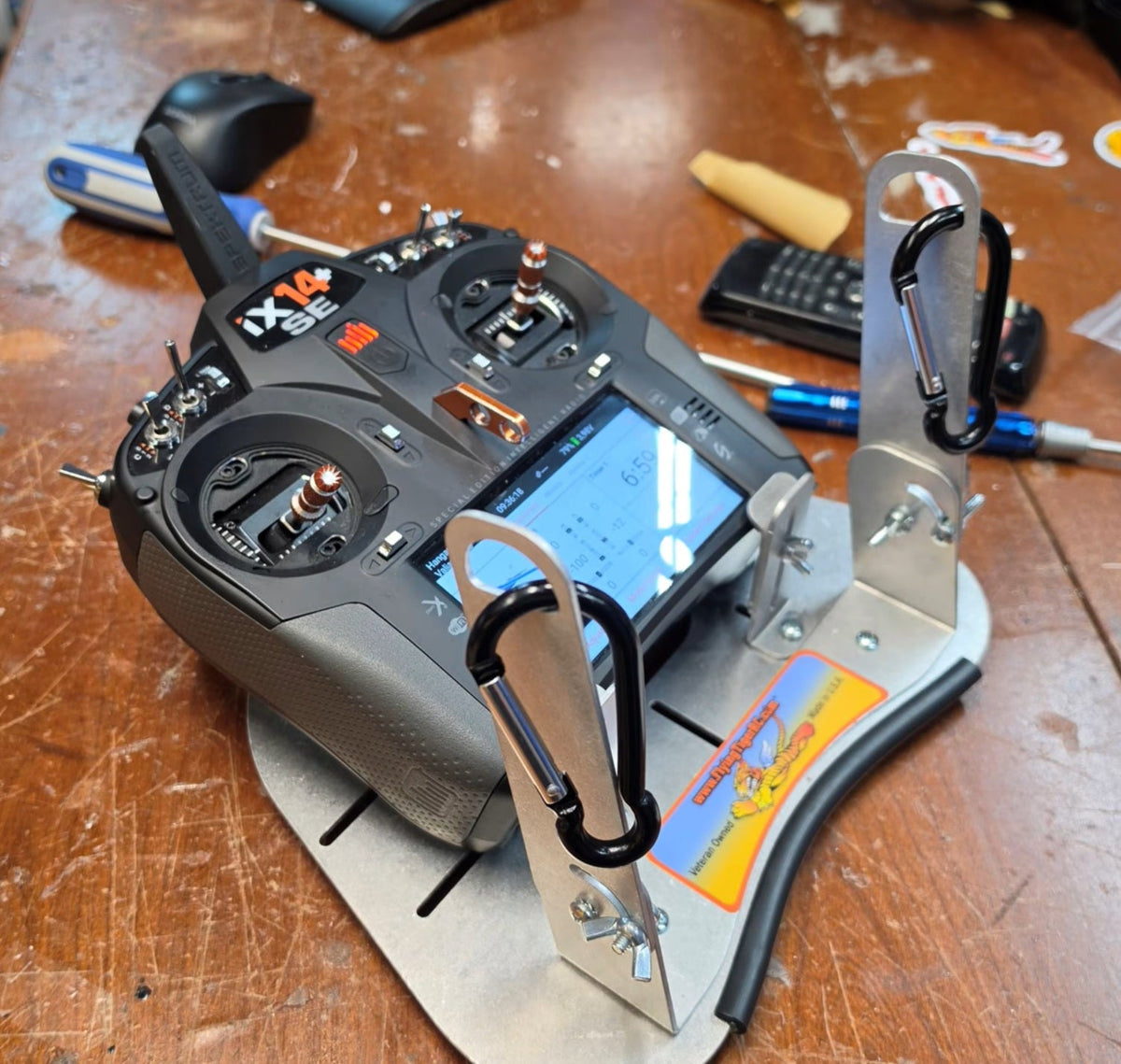 Spektrum iX14 radio mounted in the Flying Tiger RC transmitter tray on a workbench, no hand pads fitted