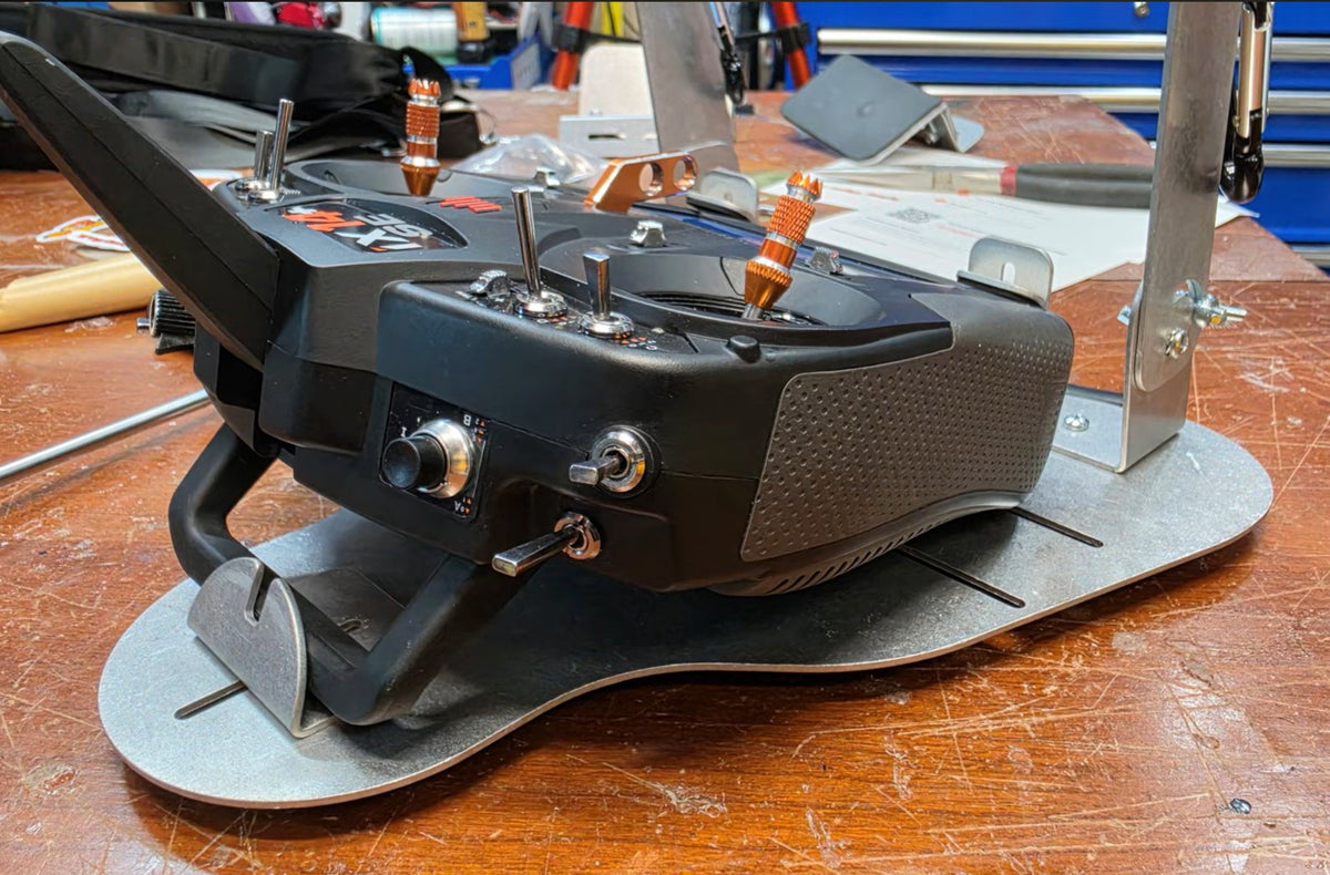 Close side view of a radio seated in the Flying Tiger RC transmitter tray, no hand pads fitted
